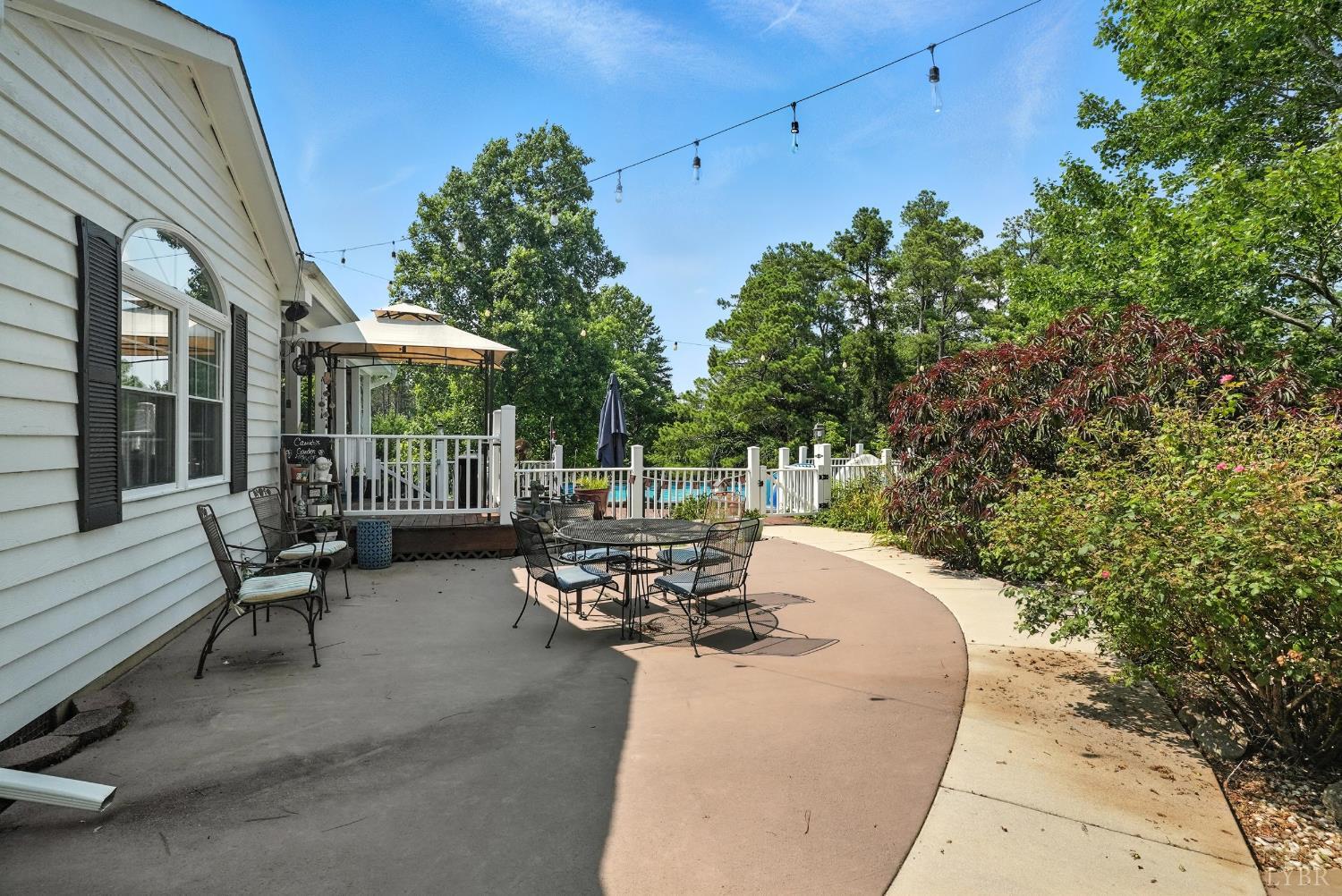1348 Salem Road Spout Spring, VA 24593 - Photo 8 of 89 a view of a patio with table and chairs and floor to ceiling window