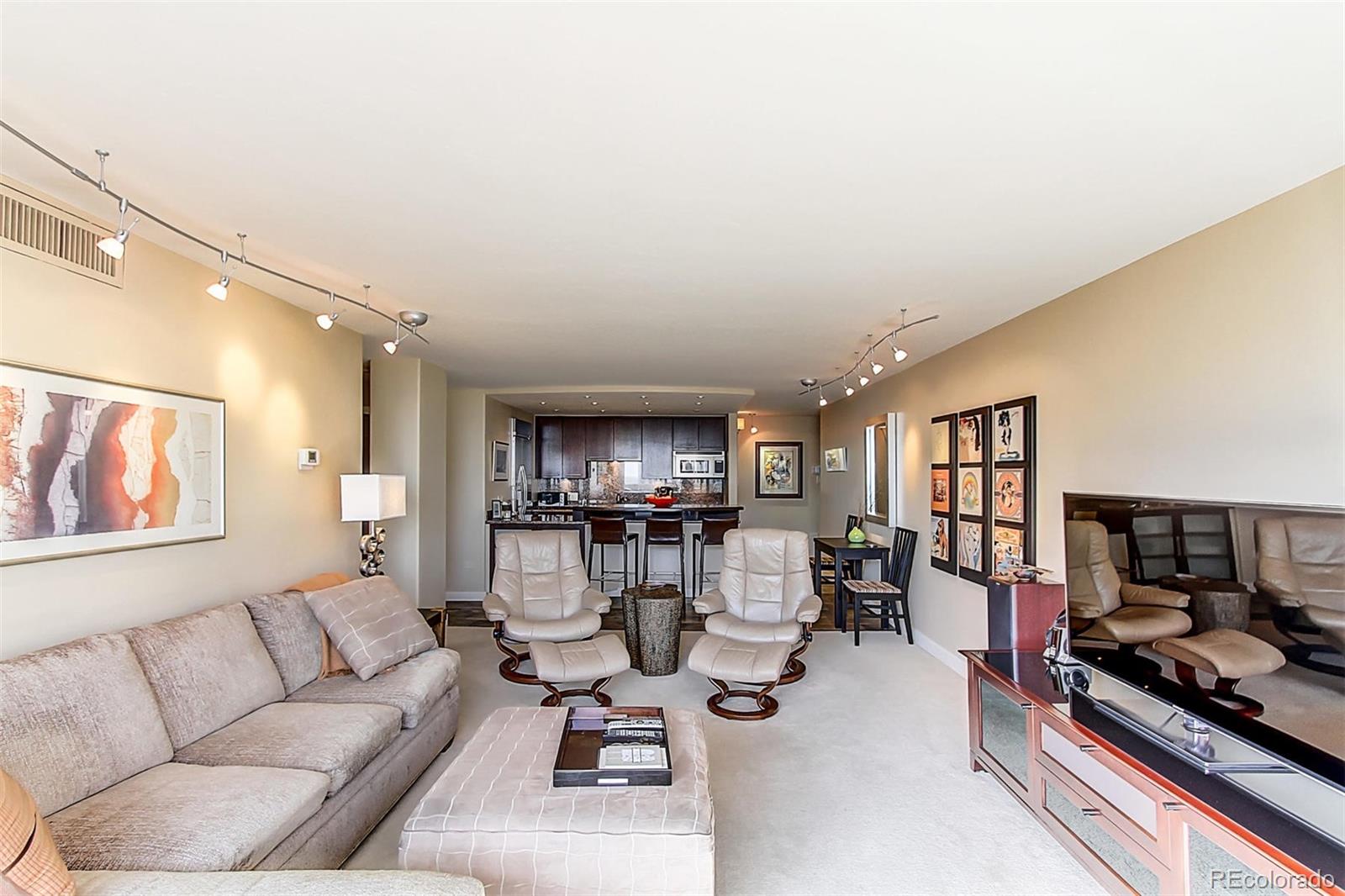 1020 15th Street, Unit 25J Denver, CO 80202 - Photo 12 of 34 a living room with furniture and a flat screen tv