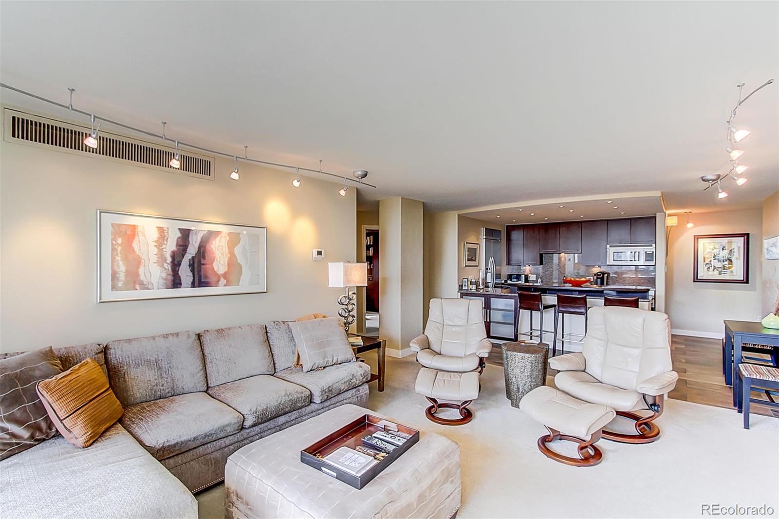 1020 15th Street, Unit 25J Denver, CO 80202 - Photo 13 of 34 a living room with furniture and a wooden floor