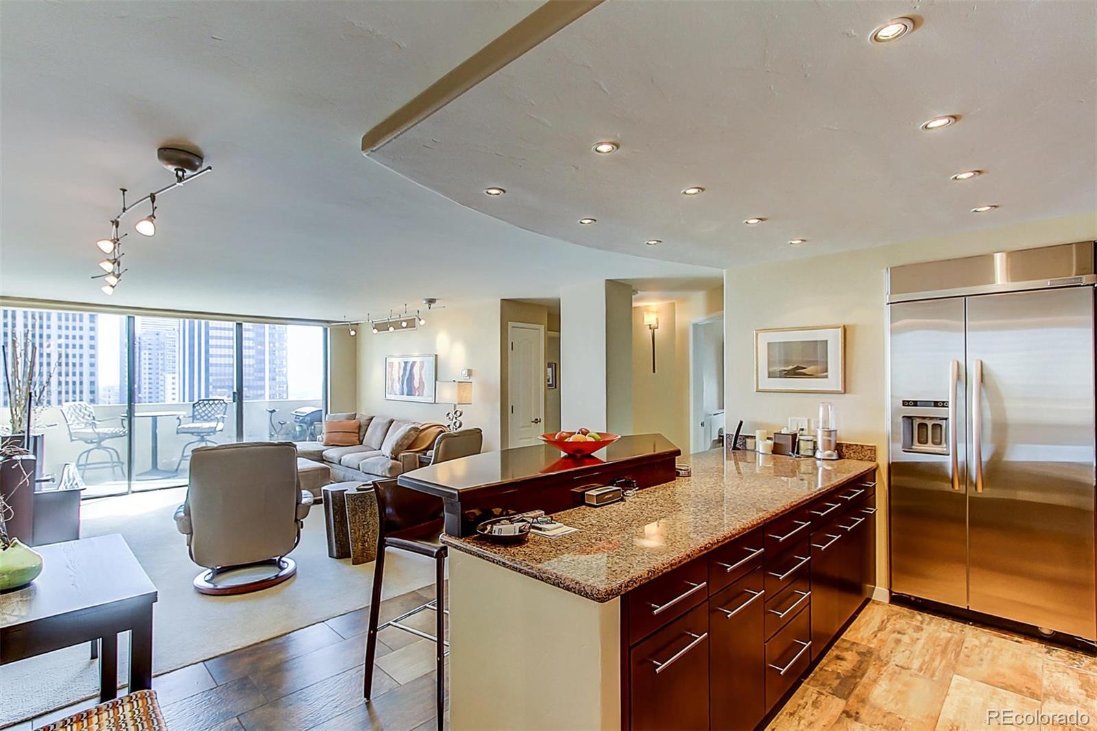 1020 15th Street, Unit 25J Denver, CO 80202 - Photo 2 of 34 a kitchen with granite countertop a sink and stove
