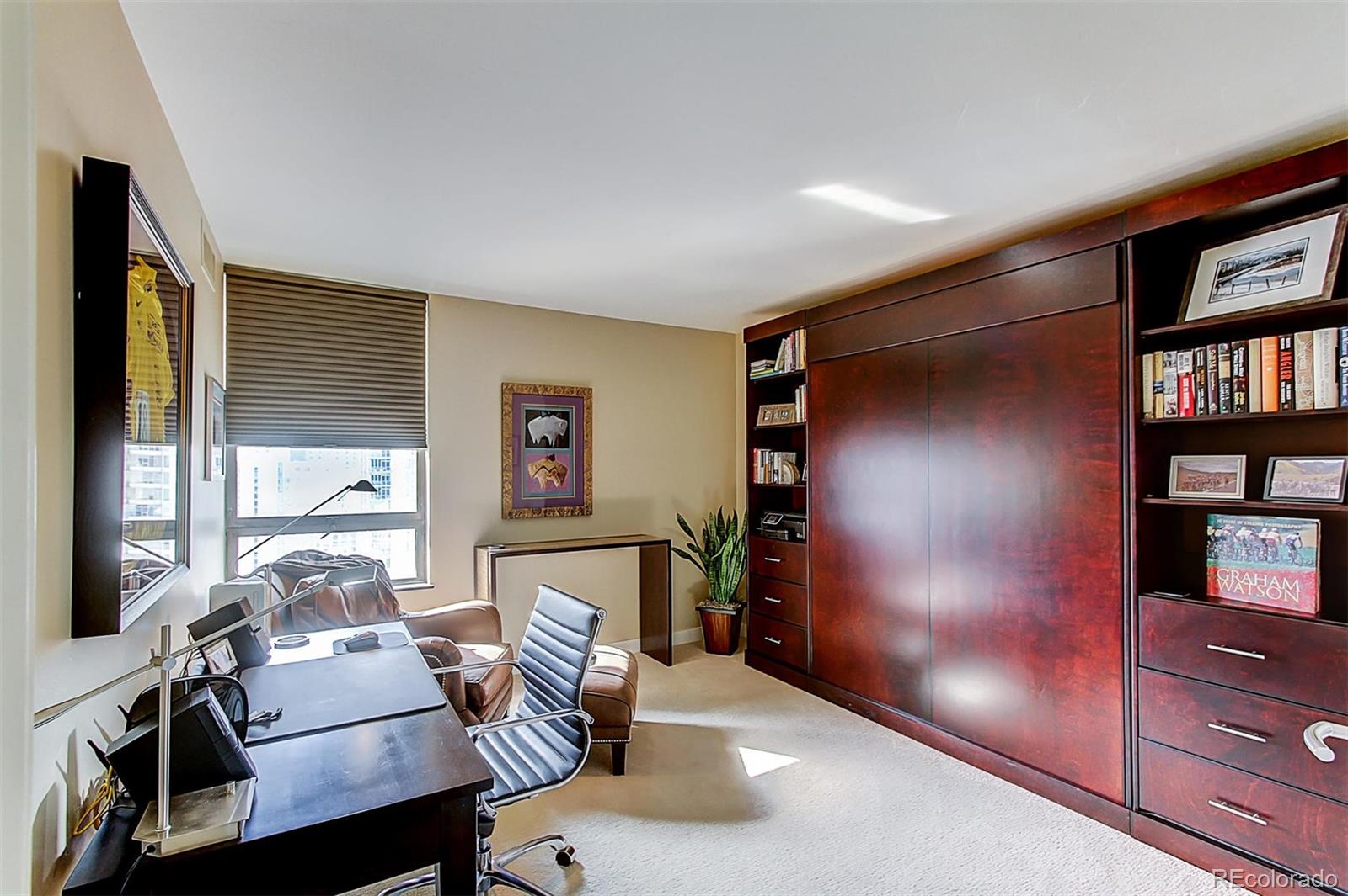 1020 15th Street, Unit 25J Denver, CO 80202 - Photo 21 of 34 a living room with furniture and a bookshelf