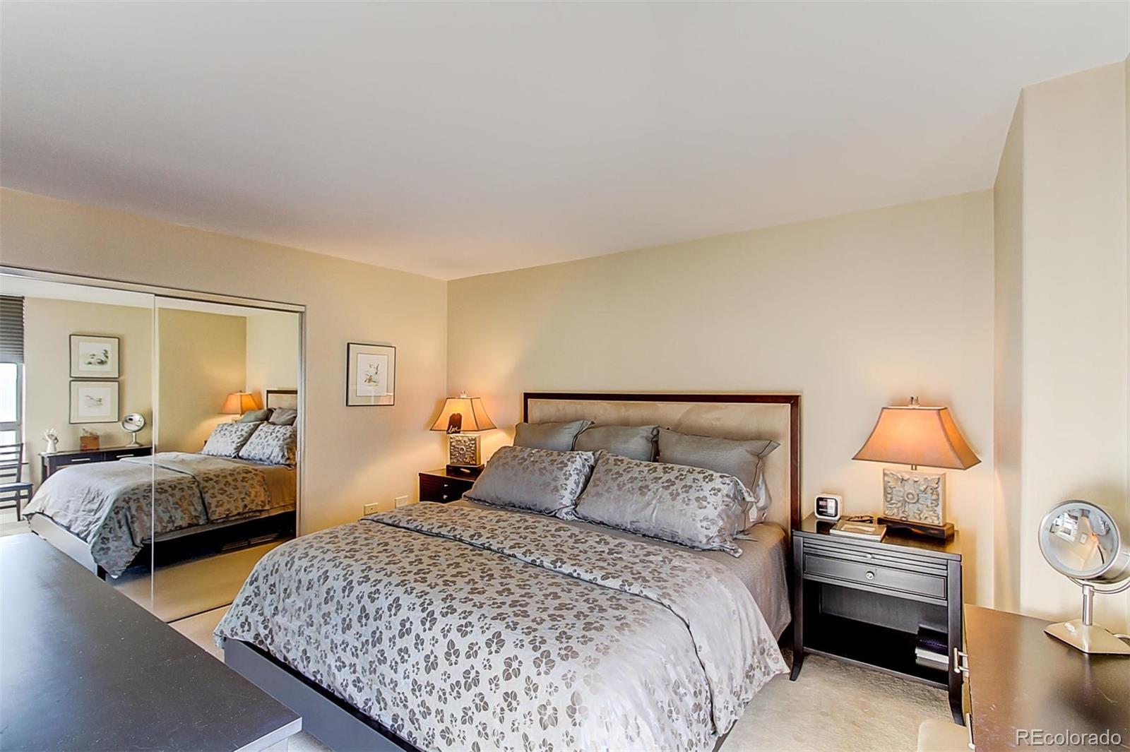 1020 15th Street, Unit 25J Denver, CO 80202 - Photo 23 of 34 a bedroom with two beds and a lamp