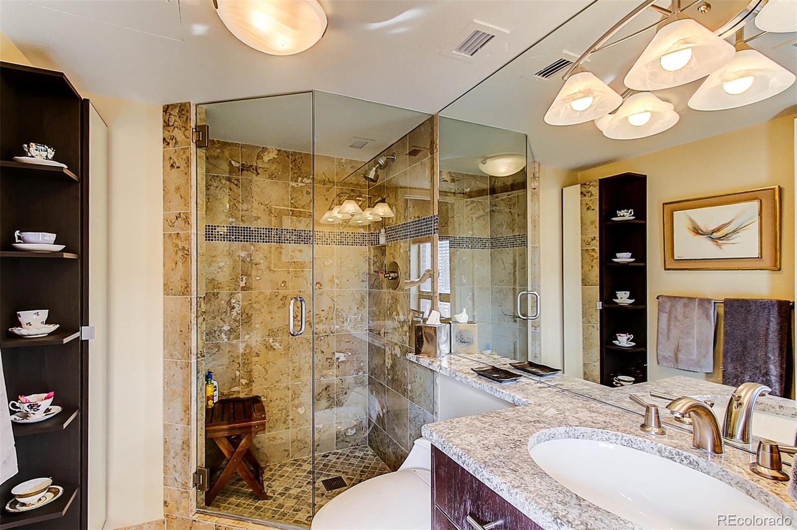 1020 15th Street, Unit 25J Denver, CO 80202 - Photo 25 of 34 a bathroom with a granite countertop sink a toilet and shower