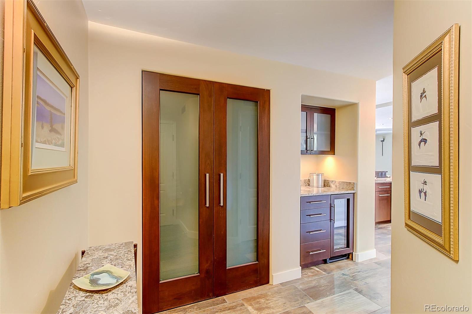 1020 15th Street, Unit 25J Denver, CO 80202 - Photo 3 of 34 a bathroom with a granite countertop sink and a mirror