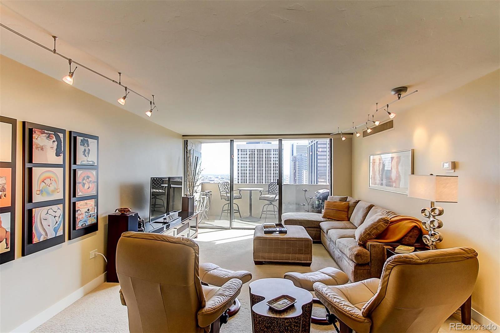1020 15th Street, Unit 25J Denver, CO 80202 - Photo 5 of 34 a living room with furniture and floor to ceiling windows