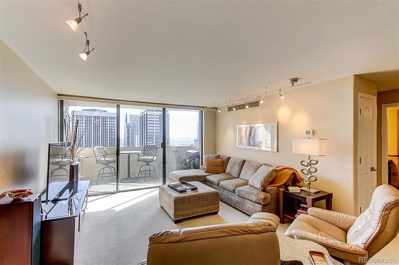 1020 15th Street, Unit 25J Denver, CO 80202 - Photo 6 of 34 a living room with furniture and a floor to ceiling window