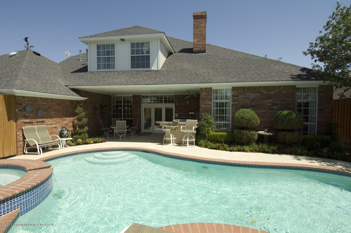 a backyard of a house with yard and outdoor seating
