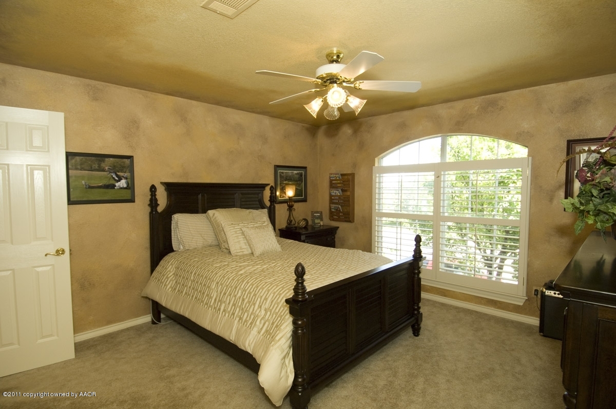 7821 Covington Parkway Amarillo, TX 79121 - Photo 12 of 53 a bed room with a bed and a chandelier