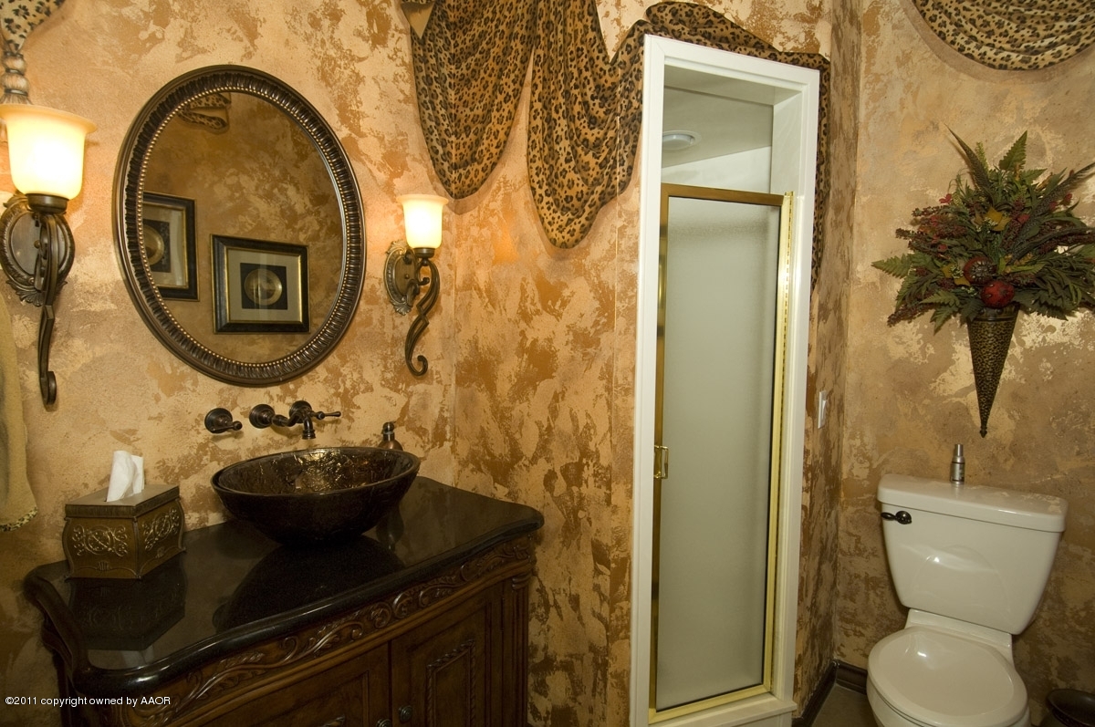 7821 Covington Parkway Amarillo, TX 79121 - Photo 6 of 53 a bathroom with a toilet mirror and vanity