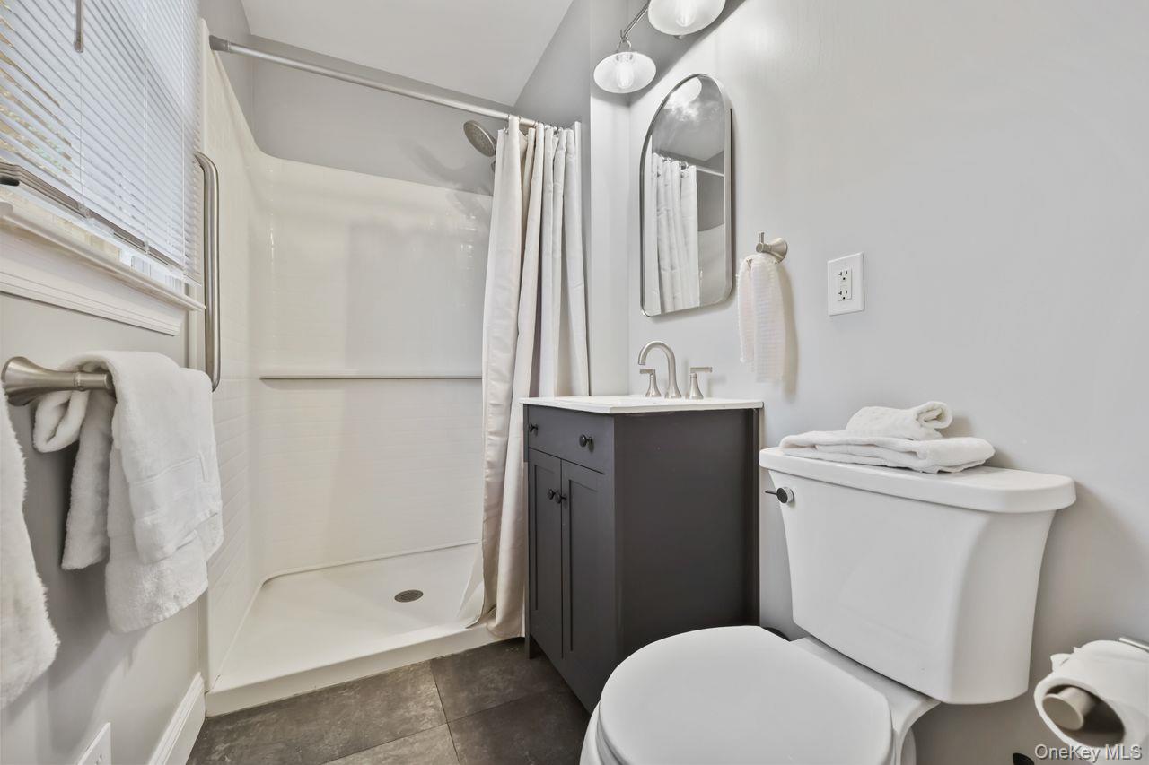 51 Knox Road Brewster, NY 10509 - Photo 18 of 31 a bathroom with a granite countertop sink toilet and shower