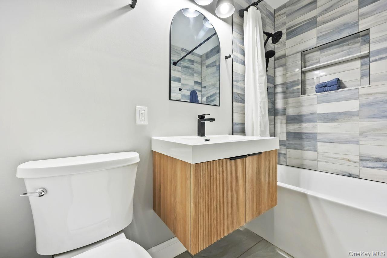 51 Knox Road Brewster, NY 10509 - Photo 20 of 31 a bathroom with a sink a toilet and a mirror