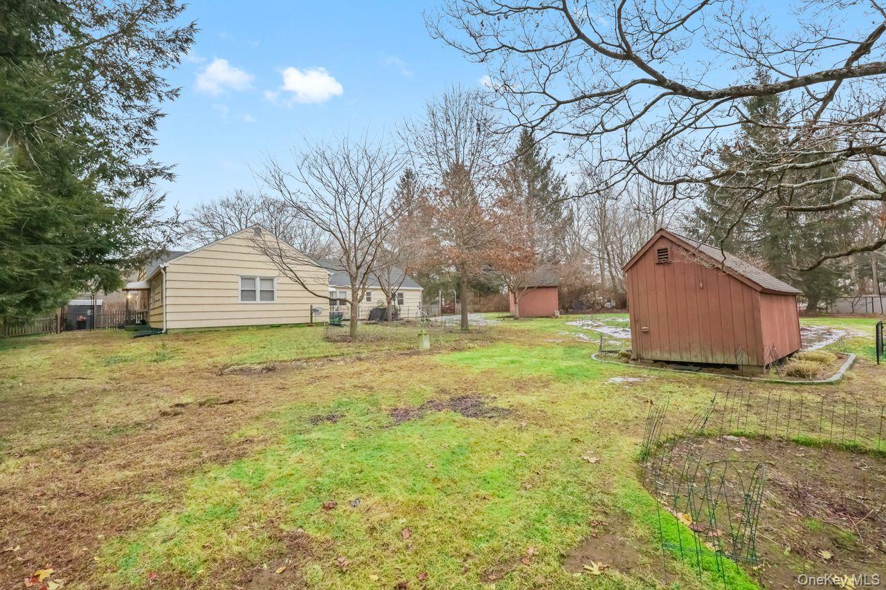 51 Knox Road Brewster, NY 10509 - Photo 26 of 31 a backyard of a house with large trees and wooden fence