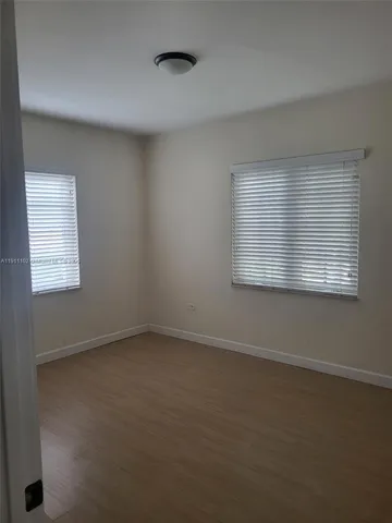 a kitchen with white cabinets and a sink