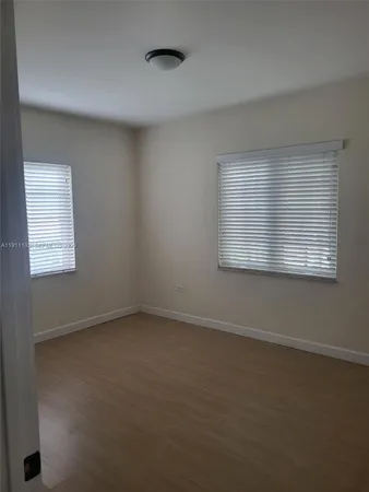 a kitchen with granite countertop white cabinets and stainless steel appliances