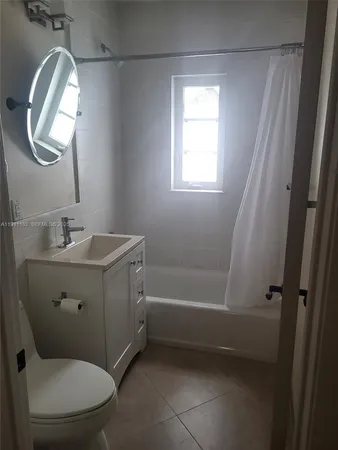 a bathroom with a sink a toilet and a shower