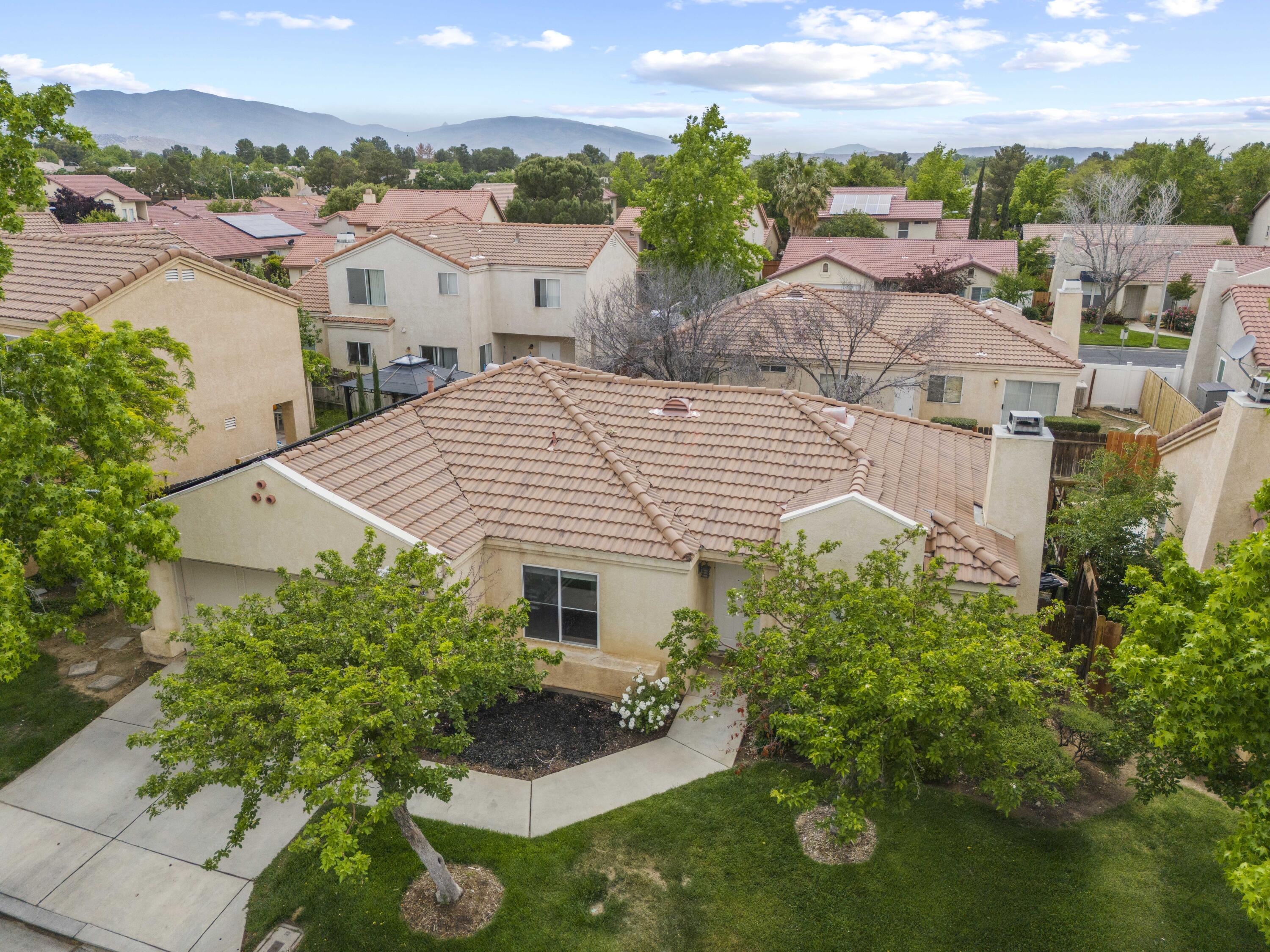 40131 La Cota Drive Palmdale, CA 93550 - Photo 21 of 26 an aerial view of multiple houses with yard