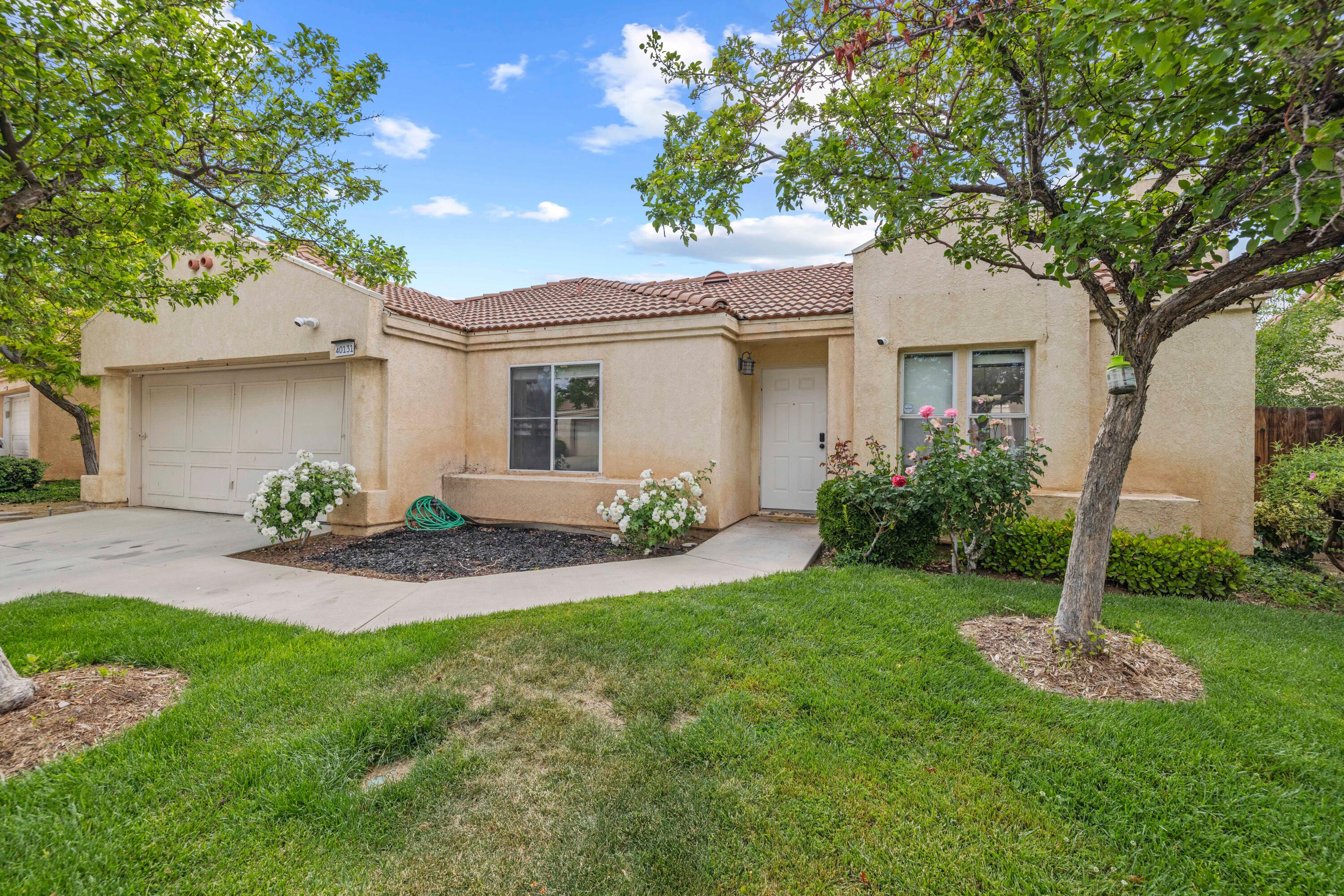 40131 La Cota Drive Palmdale, CA 93550 - Photo 3 of 26 a front view of house with yard and green space
