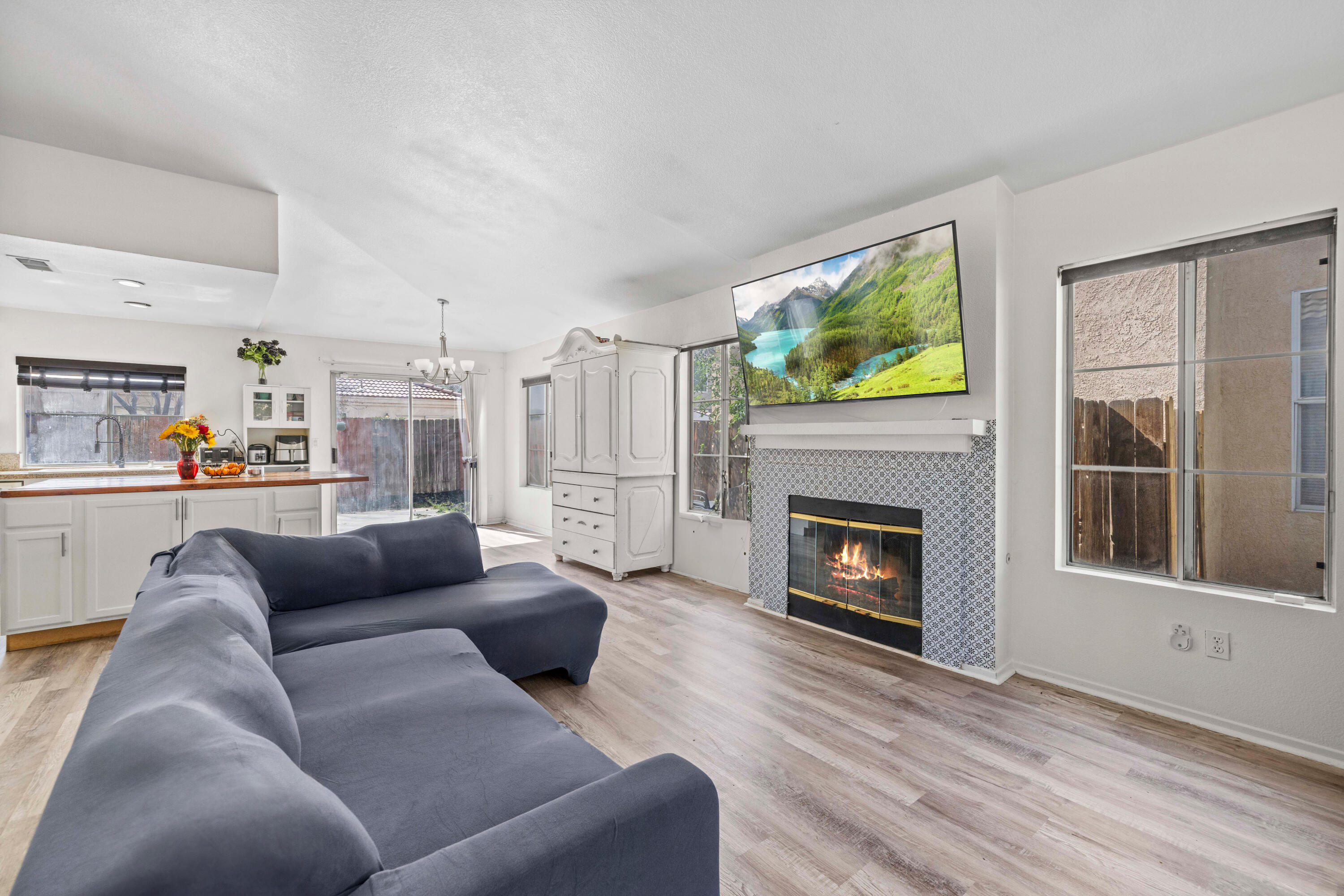 40131 La Cota Drive Palmdale, CA 93550 - Photo 4 of 26 a living room with furniture a fireplace and a flat screen tv