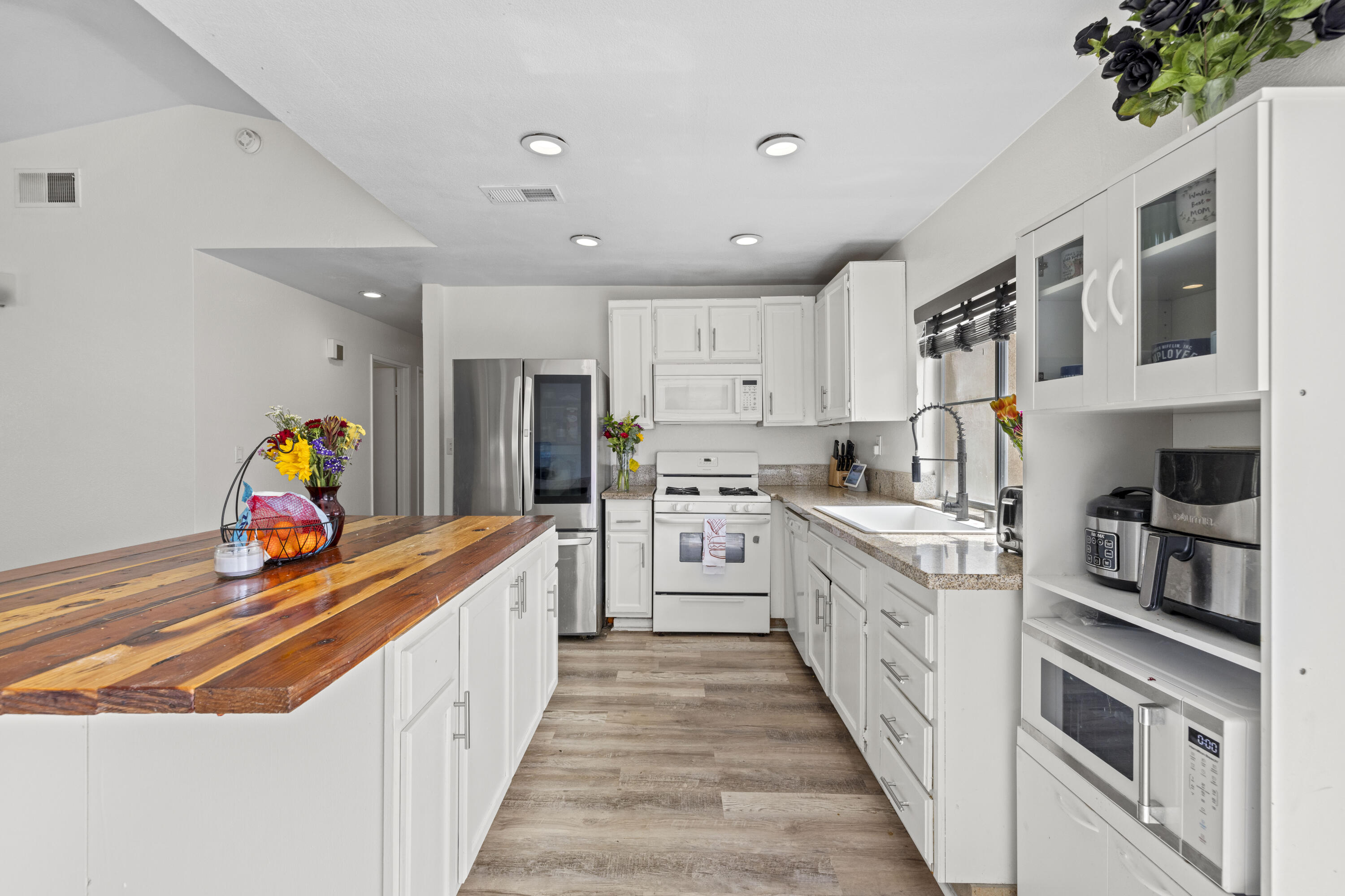 40131 La Cota Drive Palmdale, CA 93550 - Photo 9 of 26 a kitchen with stainless steel appliances granite countertop lots of counter top space and cabinets