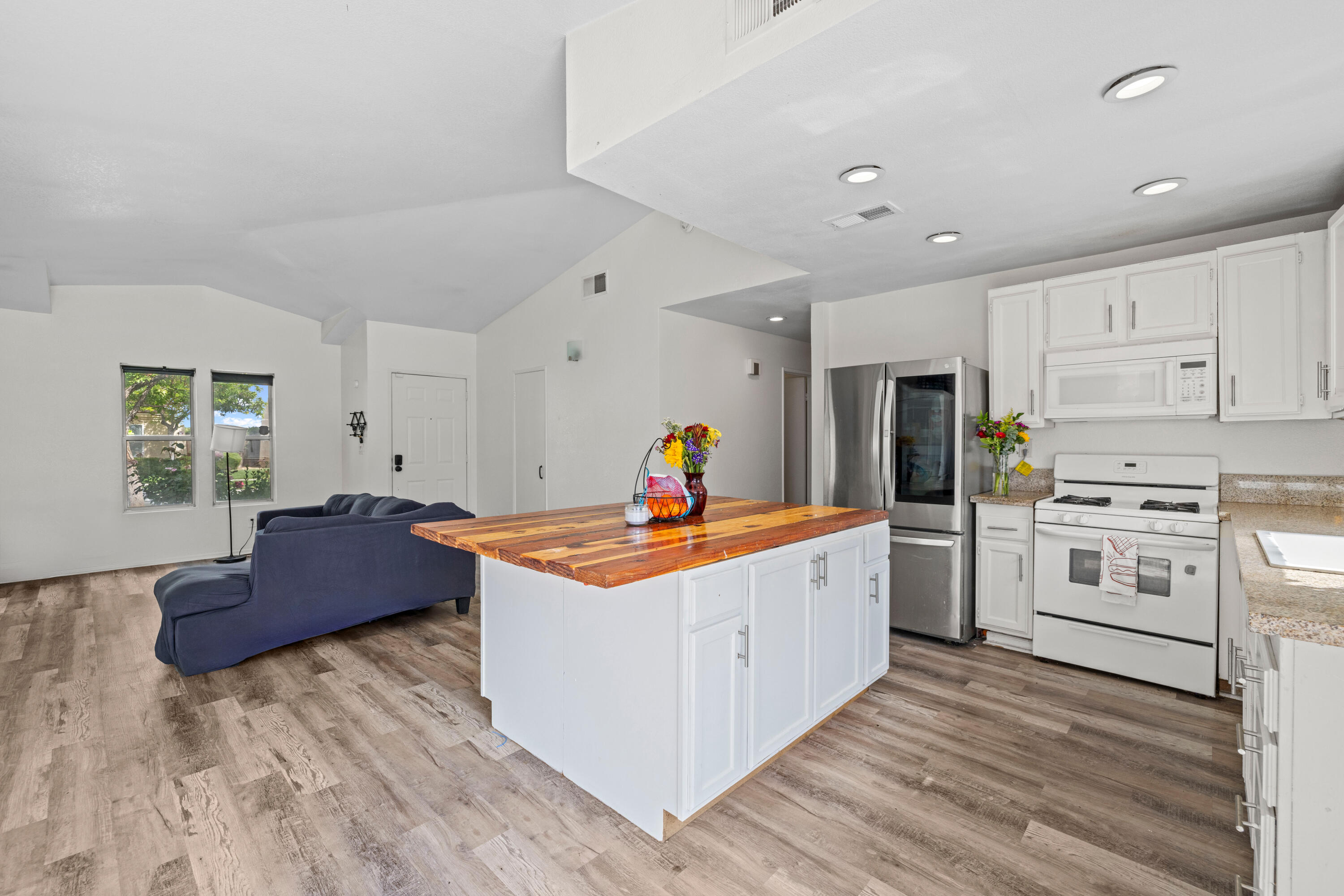 40131 La Cota Drive Palmdale, CA 93550 - Photo 10 of 26 a large white kitchen with stainless steel appliances granite countertop a stove and a refrigerator