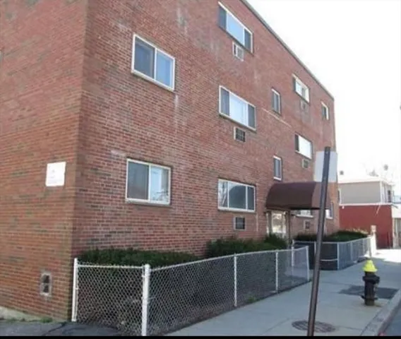 a front view of a building with parking