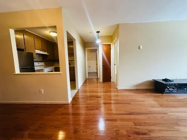 a view of a living room with wooden floor