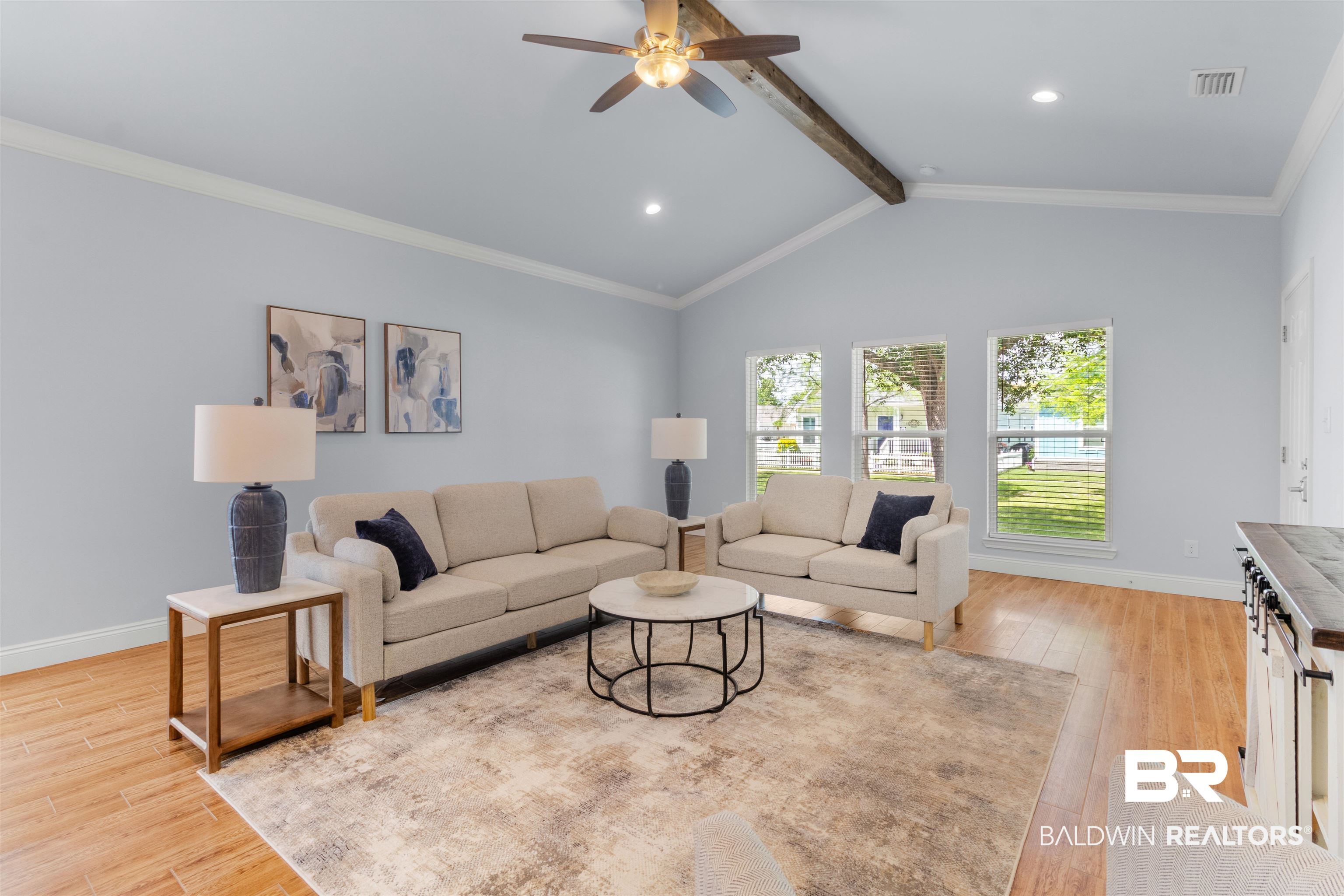 927 Periwinkle Lane Foley, AL 36535 - Photo 5 of 26 Spacious living area featuring a vaulted ceiling with exposed wood beam, wood-finish flooring, recessed lighting, and multiple windows