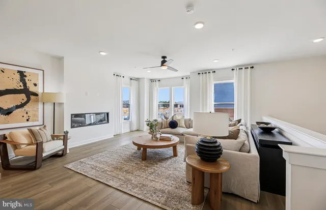 a living room with furniture and wooden floor