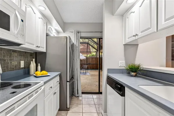 a kitchen with stainless steel appliances white cabinets and a stove top oven
