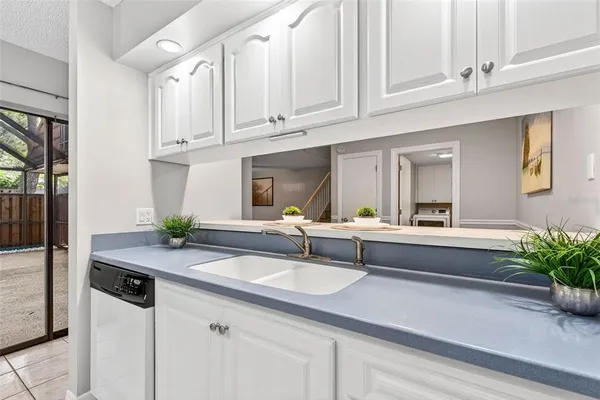a utility room with sink dryer and washer