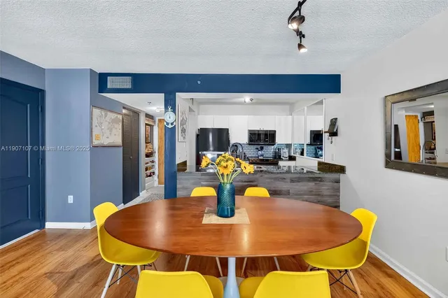 a view of a dining room with furniture and wooden floor