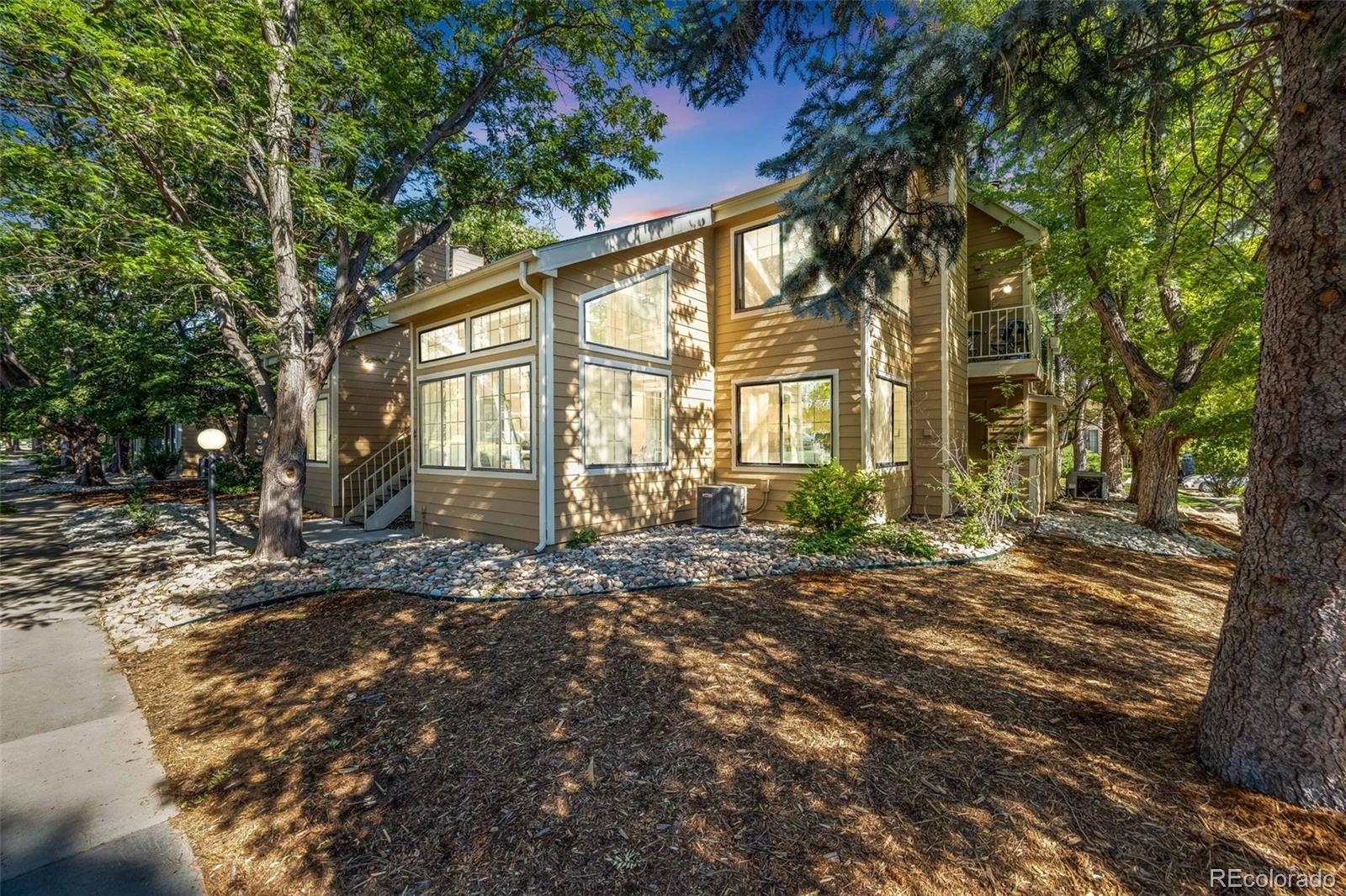 a view of a house with a tree in front