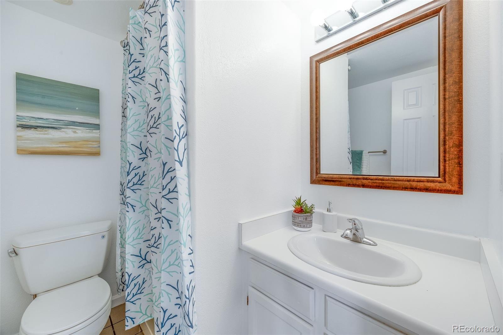 4811 White Rock Circle, Unit C Boulder, CO 80301 - Photo 13 of 19 a bathroom with a toilet sink and mirror