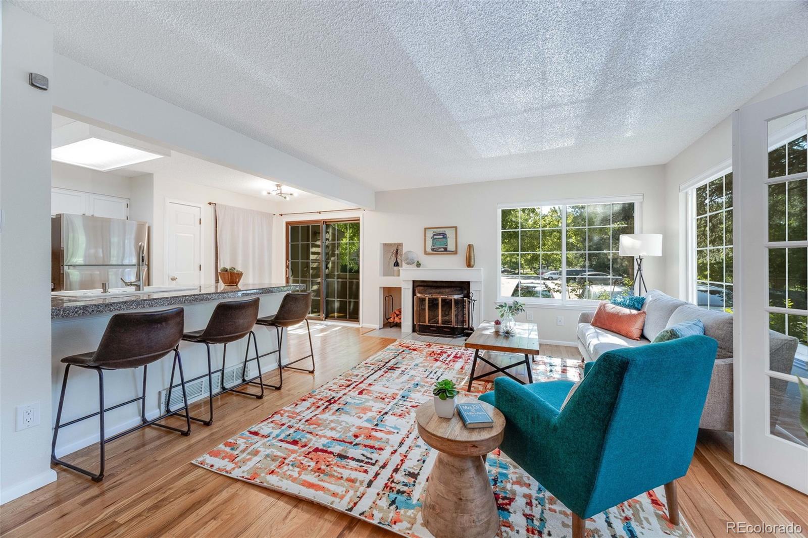 4811 White Rock Circle, Unit C Boulder, CO 80301 - Photo 3 of 19 a living room with furniture a fireplace and a table