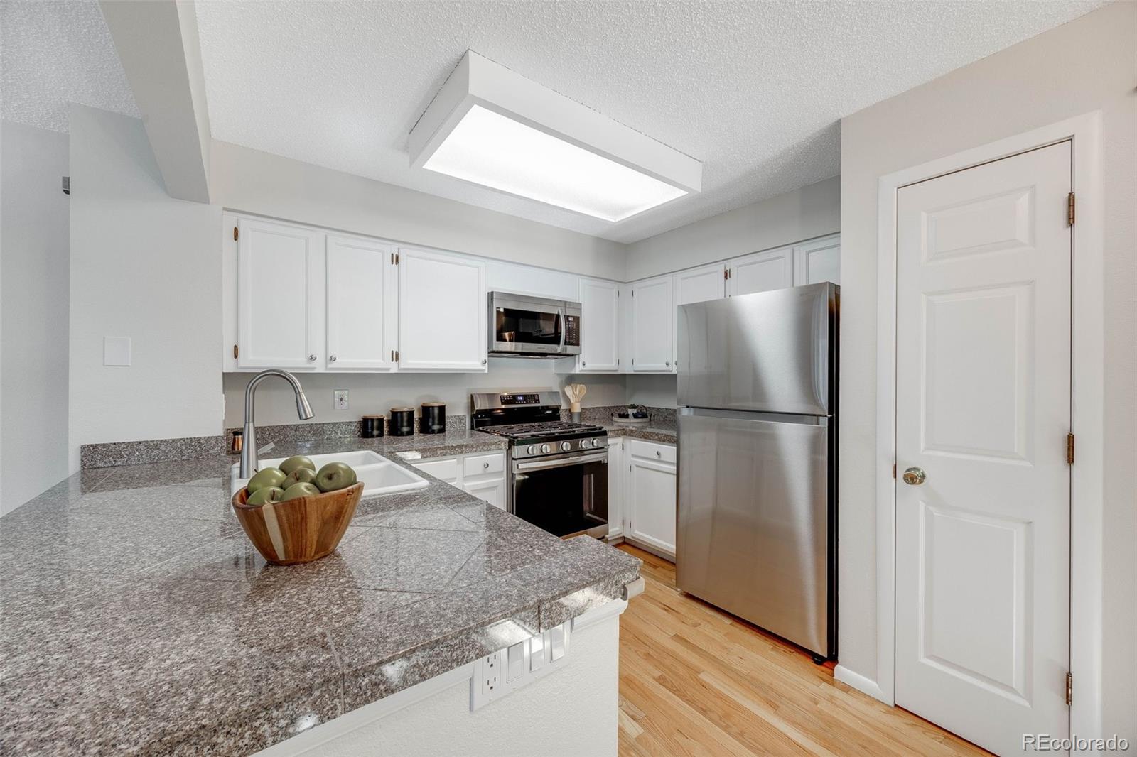 4811 White Rock Circle, Unit C Boulder, CO 80301 - Photo 6 of 19 a kitchen with a refrigerator a stove top oven a sink and dishwasher