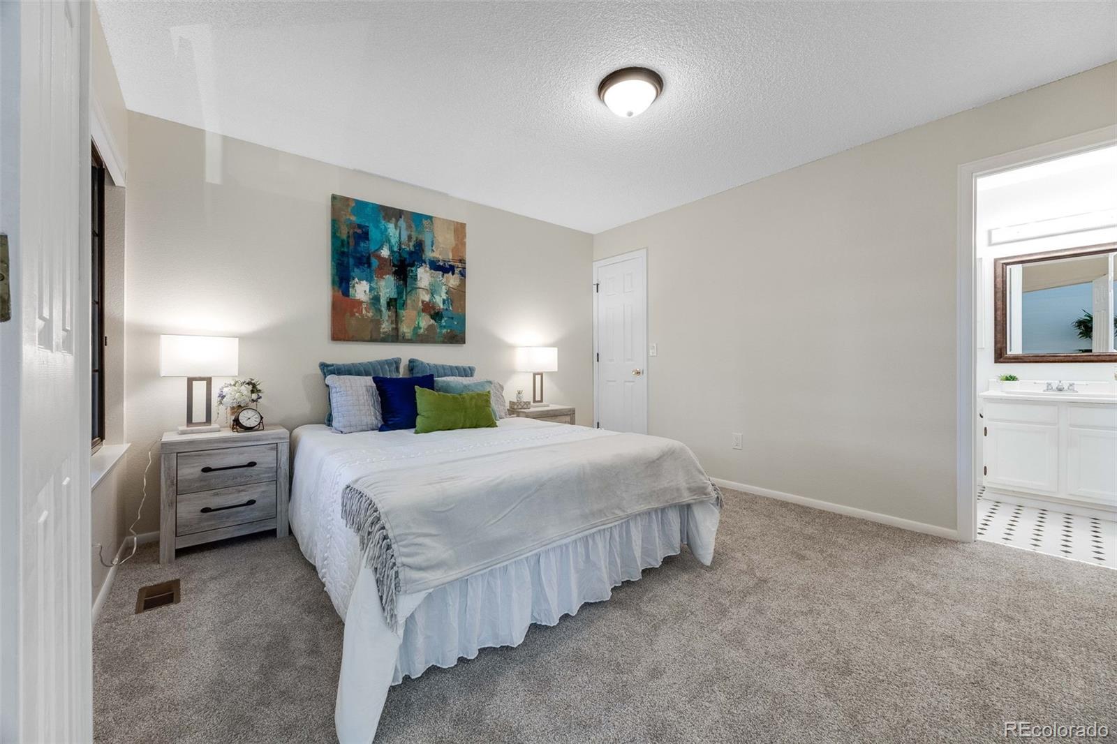 4811 White Rock Circle, Unit C Boulder, CO 80301 - Photo 9 of 19 a bedroom with a bed and a chandelier