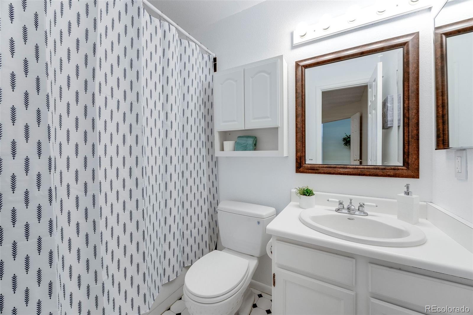 4811 White Rock Circle, Unit C Boulder, CO 80301 - Photo 10 of 19 a bathroom with a sink a toilet and mirror