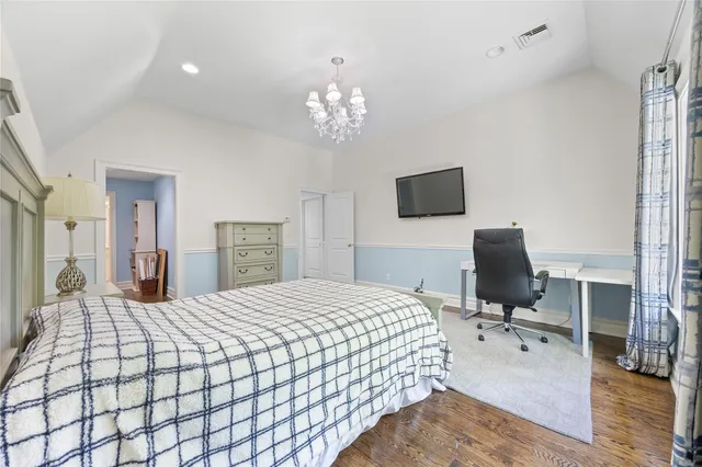 a bedroom with a bed window and a flat screen tv