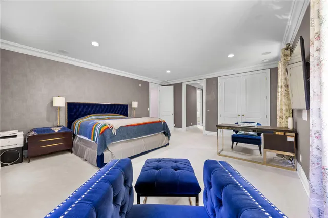 a bedroom with furniture and a large window