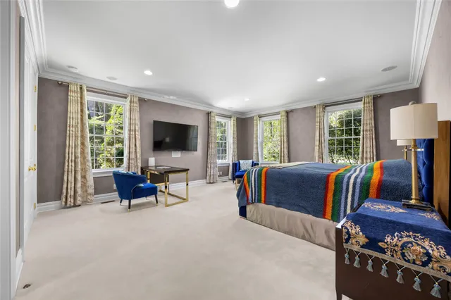 a bedroom with furniture and a flat screen tv