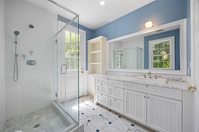 a bathroom with a sink mirror vanity and toilet