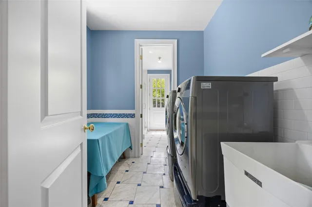 a view of a house with a yard and potted plants