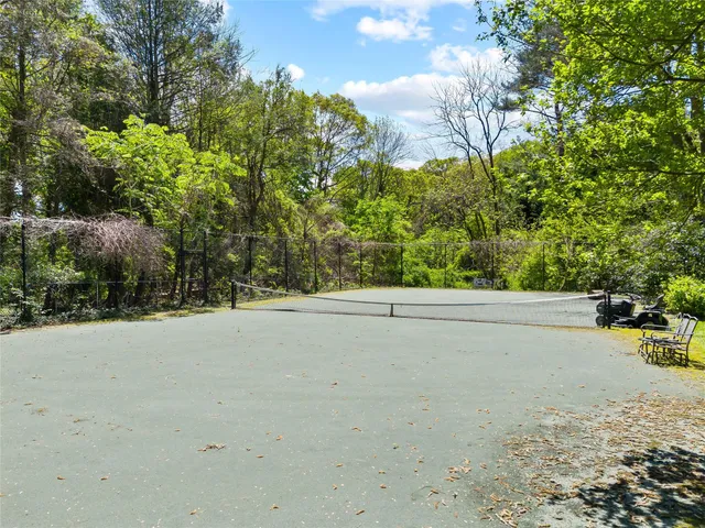 an aerial view of residential house with outdoor space and trees all around