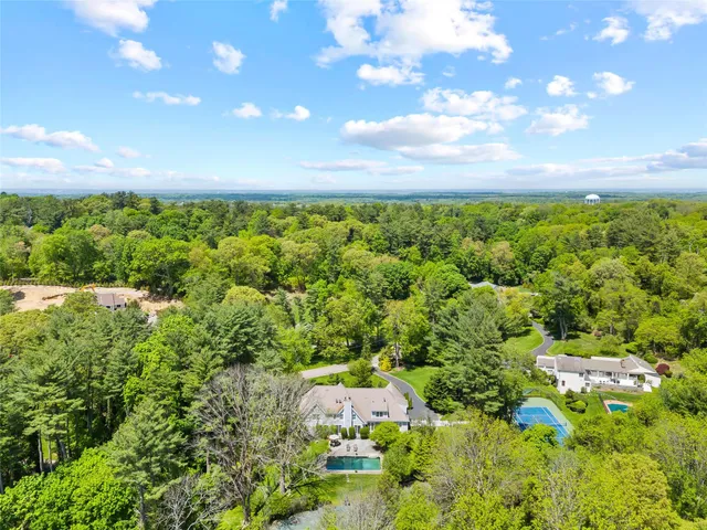 an aerial view of a house with a yard swimming pool and outdoor seating