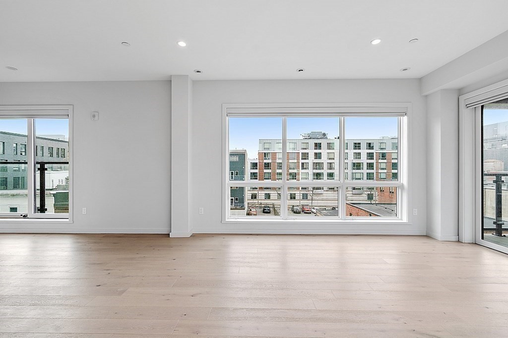 100 A Street, Unit 6 Boston, MA 02127 - Photo 18 of 37 a view of an empty room with a window and wooden floor
