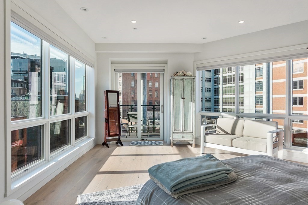 100 A Street, Unit 6 Boston, MA 02127 - Photo 19 of 37 a spacious bedroom with a large window and a couch