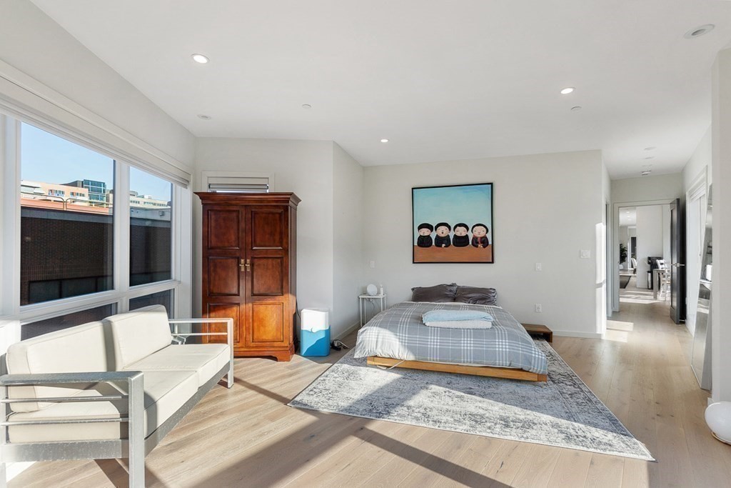 100 A Street, Unit 6 Boston, MA 02127 - Photo 20 of 37 a bedroom with furniture and flat screen tv