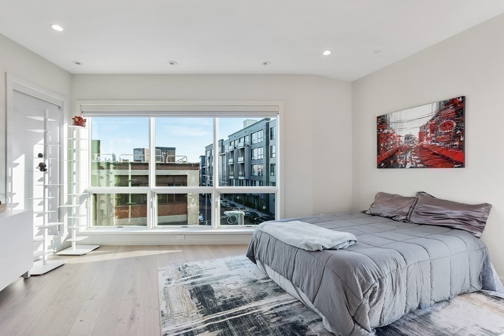 100 A Street, Unit 6 Boston, MA 02127 - Photo 24 of 37 a bedroom with a large bed and a large window