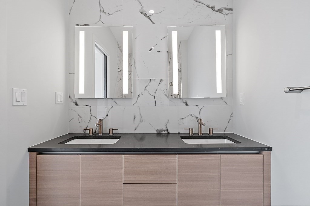 100 A Street, Unit 6 Boston, MA 02127 - Photo 26 of 37 a bathroom with cabinets and white countertops