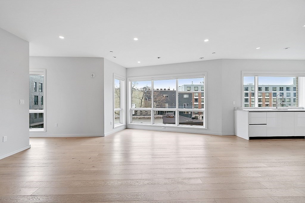 100 A Street, Unit 6 Boston, MA 02127 - Photo 6 of 37 a view of an empty room with wooden floor and a window